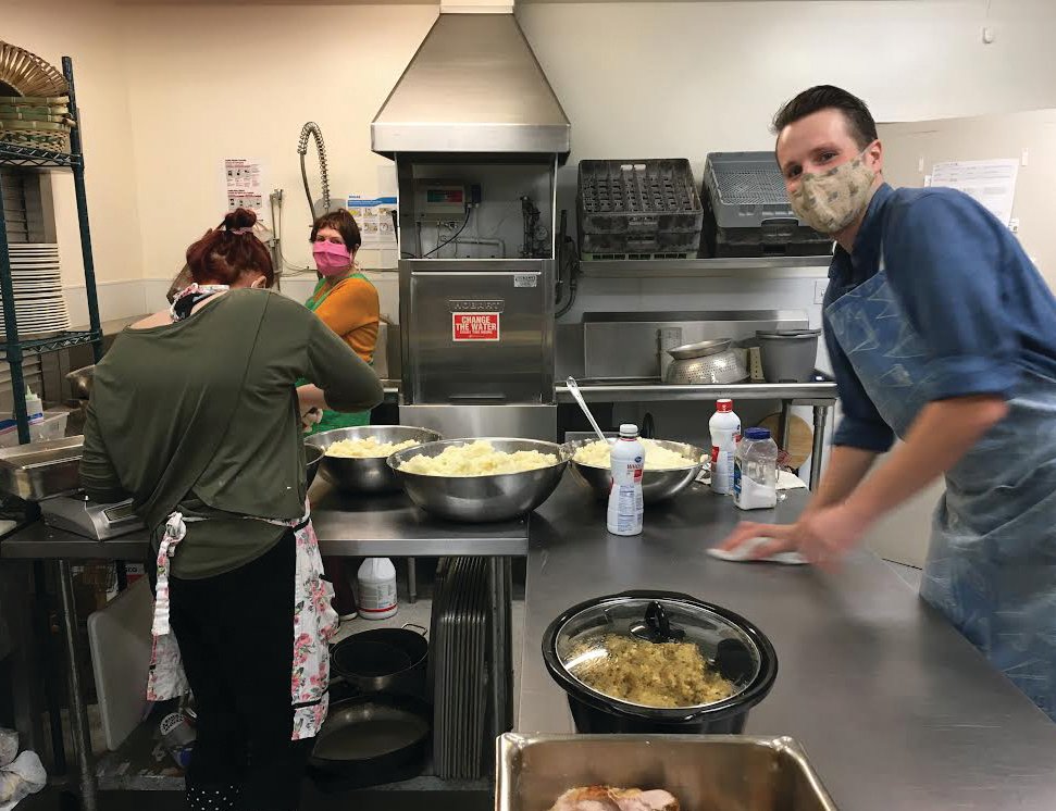 Volunteers from a previous season help with preparations of the annual Tri-Area Community Christmas meal.